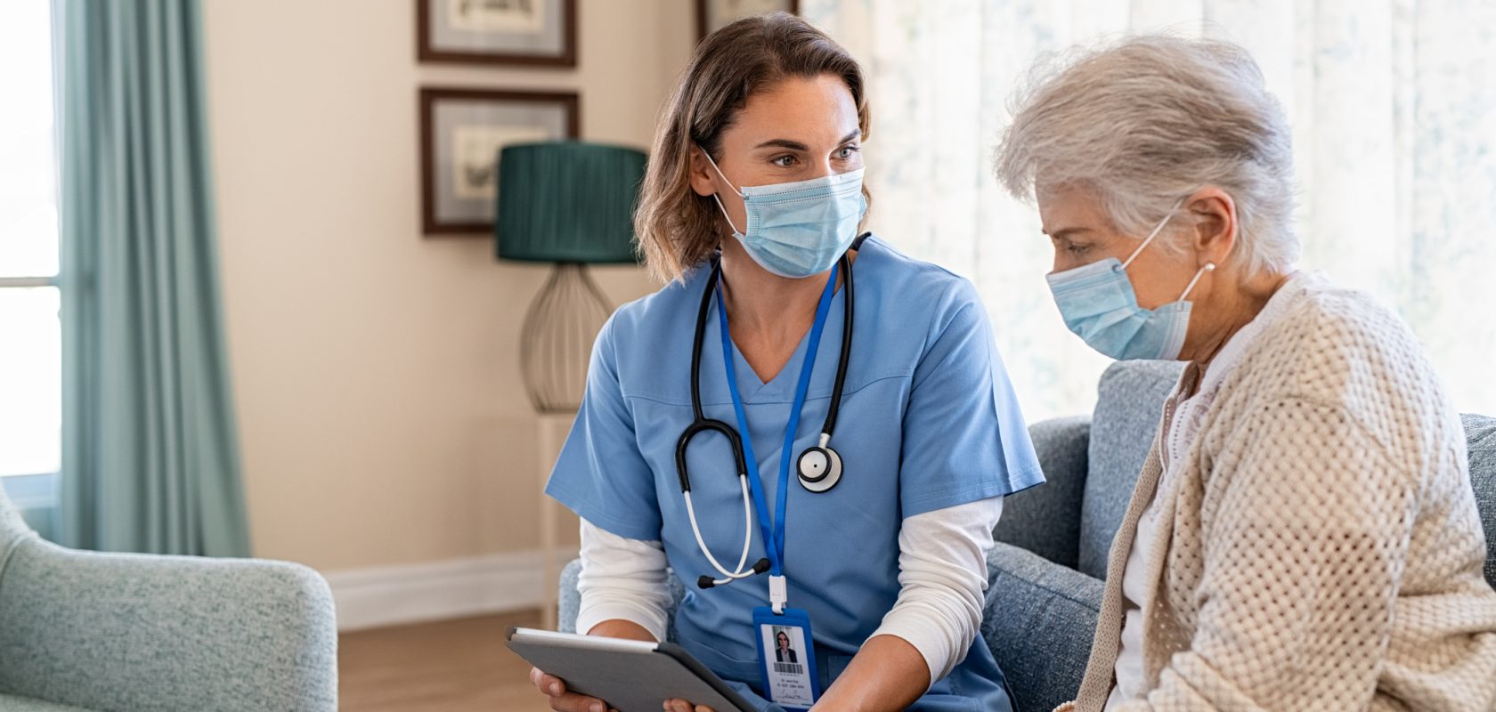 Doctor in mask talking to patient